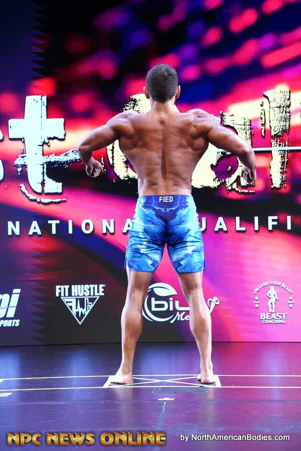 Men's Physique back pose during the show-day competition