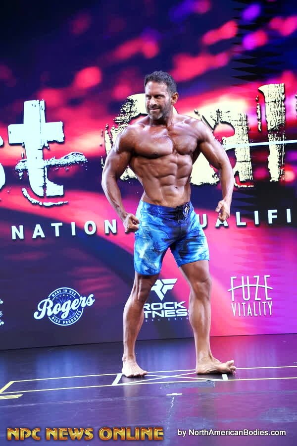 Men's Physique front pose during the show-day competition